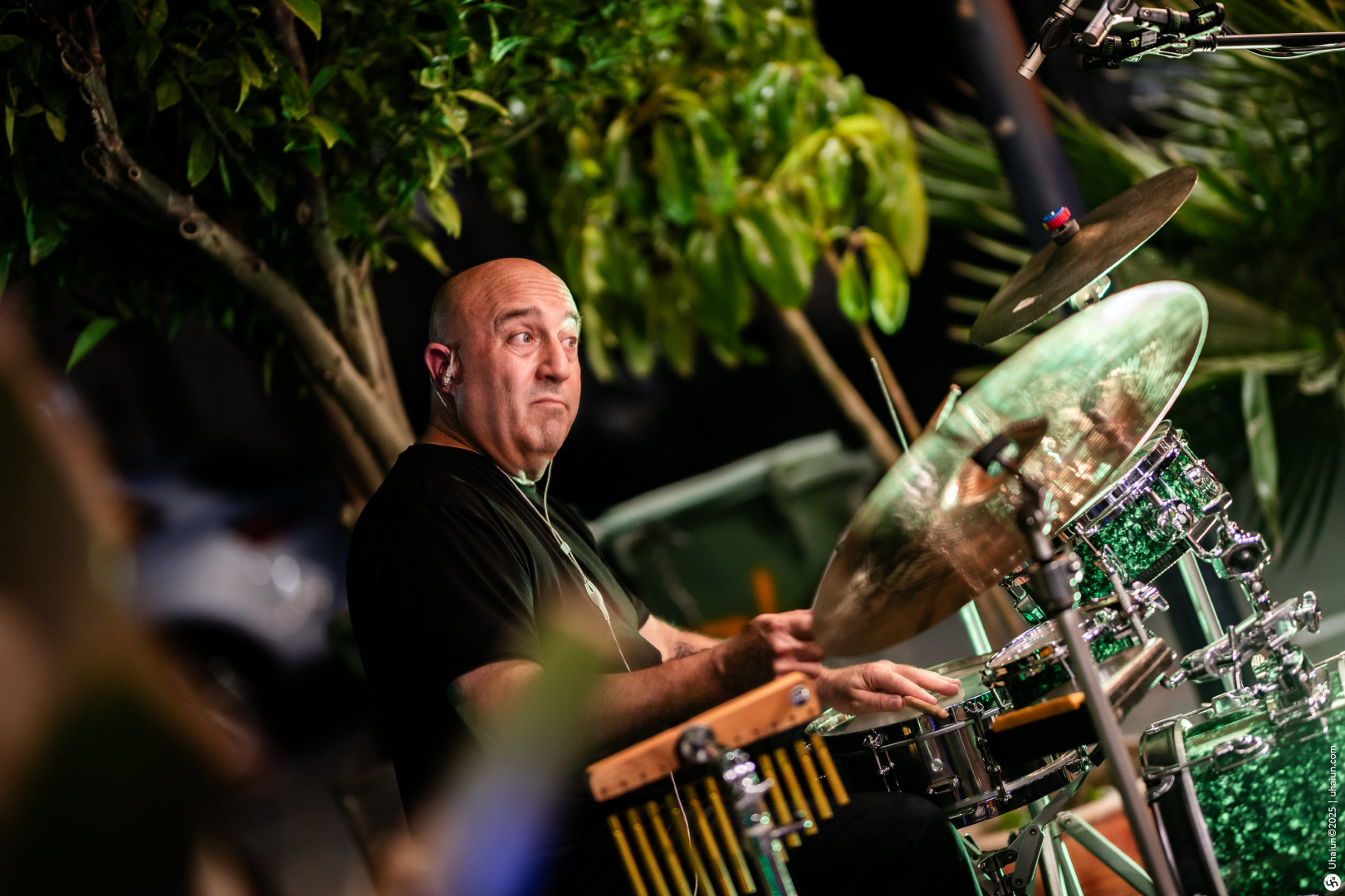 Drummer performing in vibrant outdoor setting