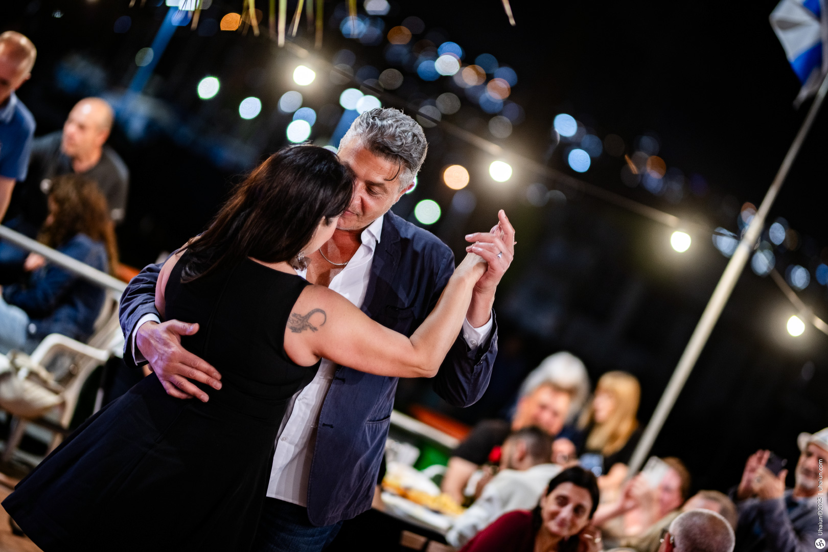 Couple dancing at outdoor evening event gathering