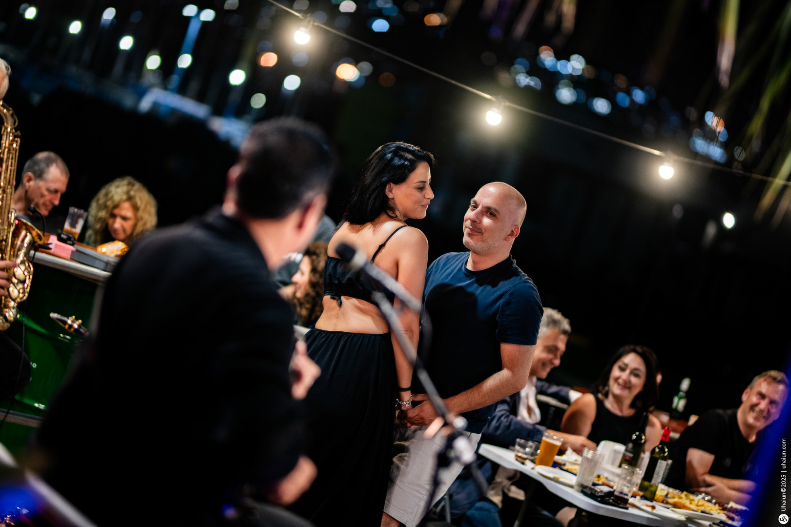 Couple enjoying live music at outdoor dinner