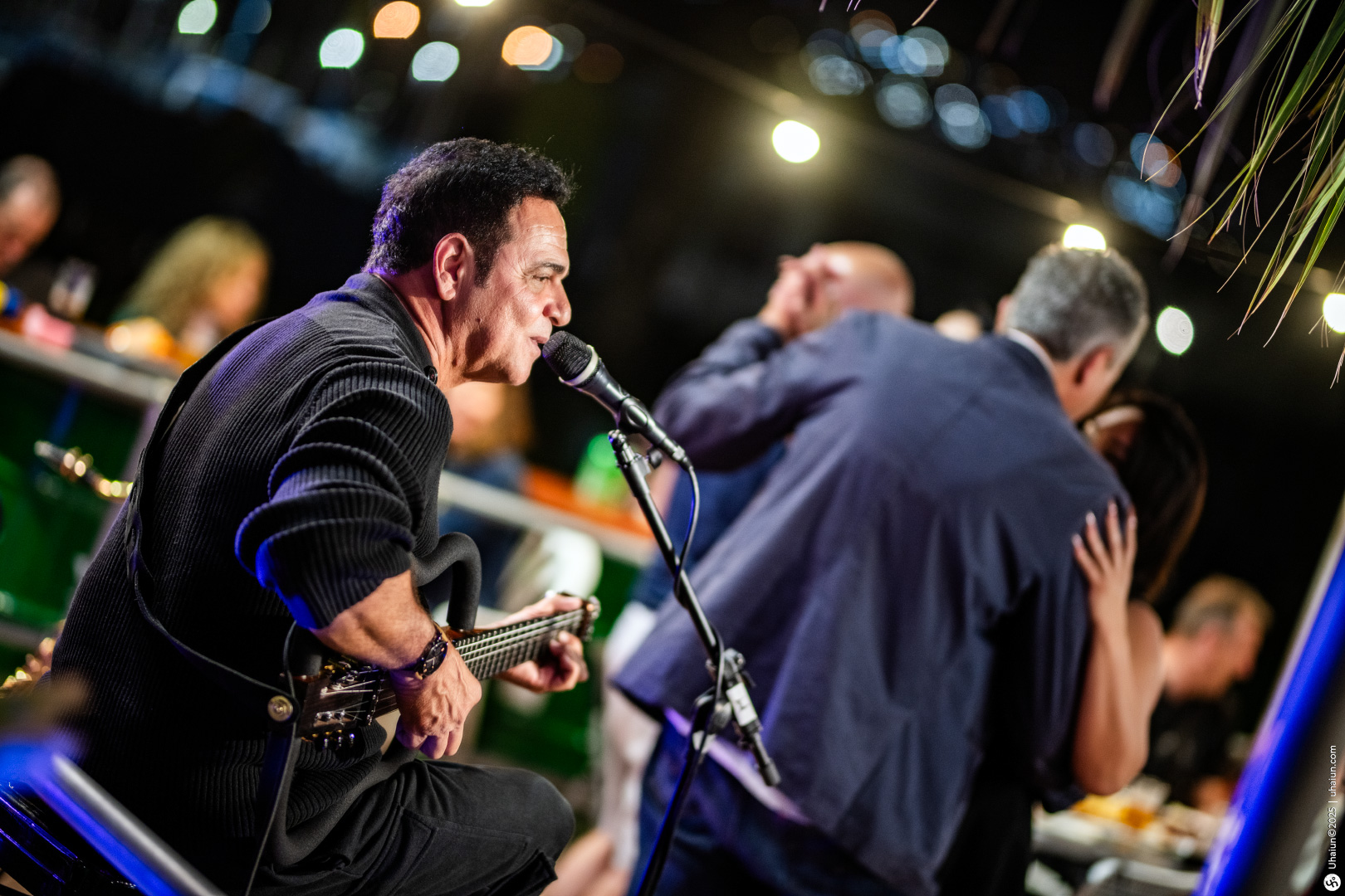 Musician performing at lively outdoor gathering event
