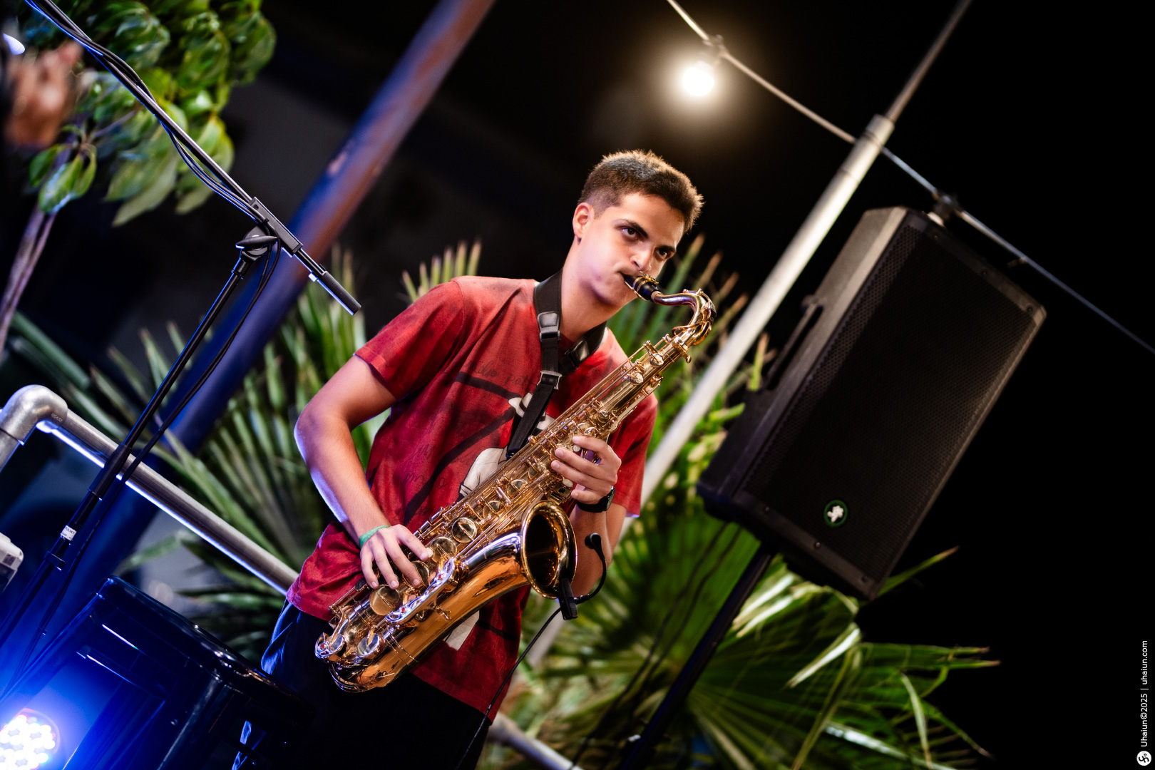 Young musician playing saxophone at outdoor event