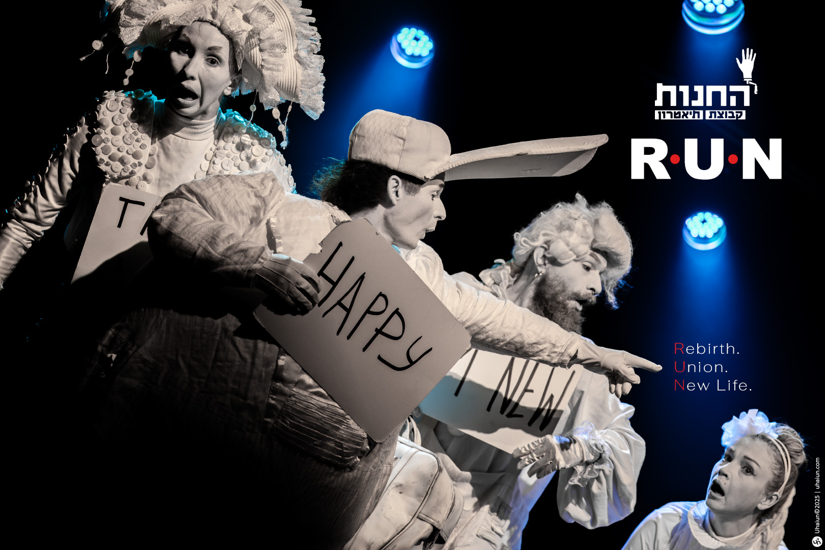 Performers on stage holding expressive signs