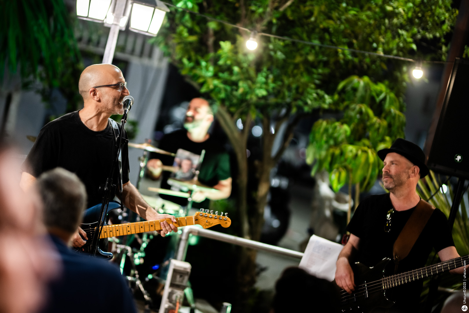 Musicians performing live outdoor concert at night