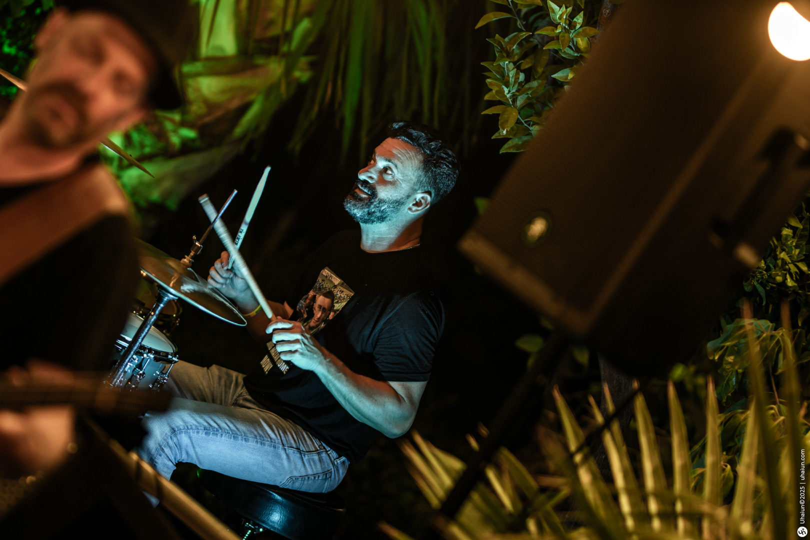 Drummer performing live at outdoor concert event