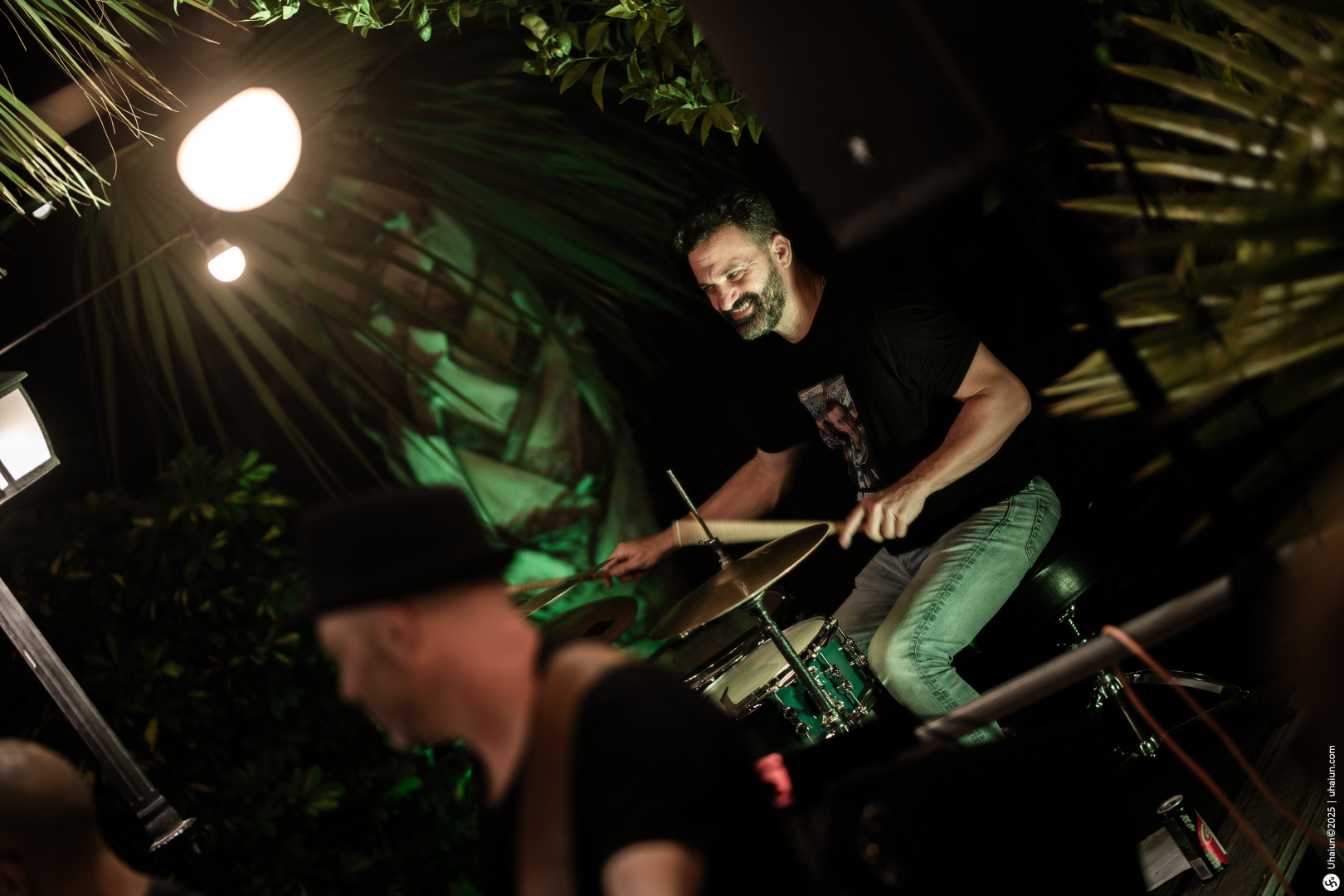 Drummer performing at lively outdoor music event