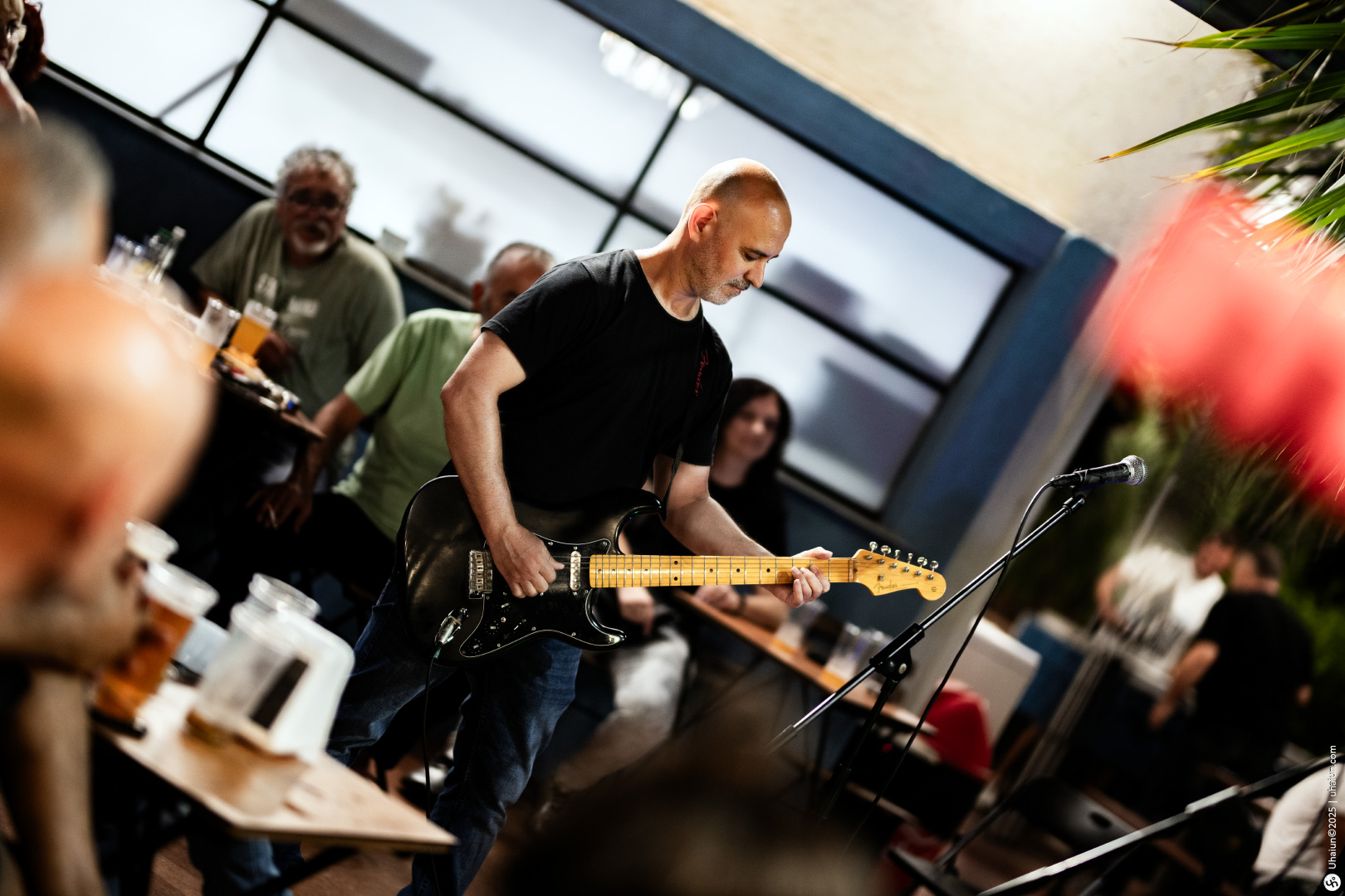 Musician playing electric guitar at lively event