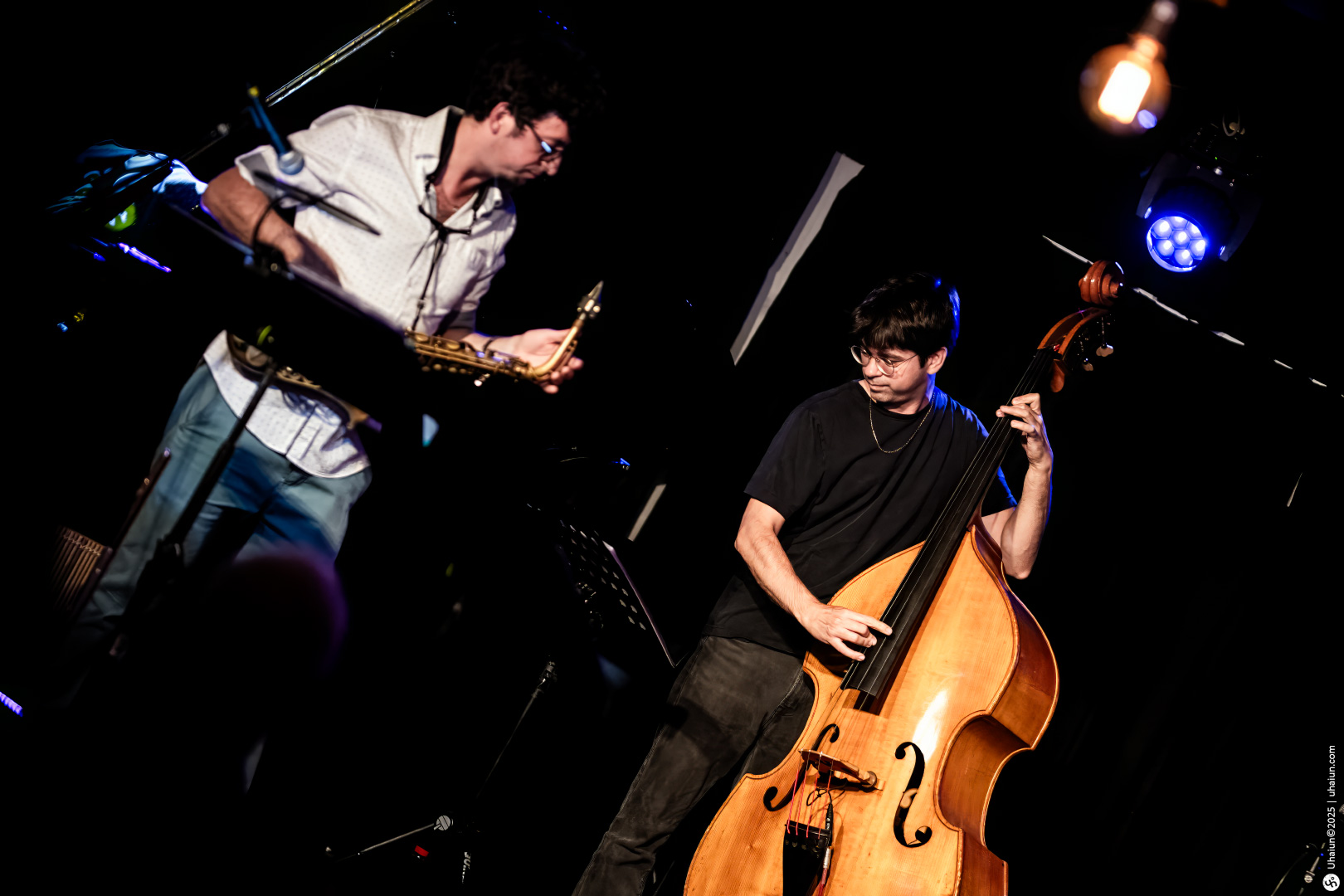 Jazz musicians performing with saxophone and double bass