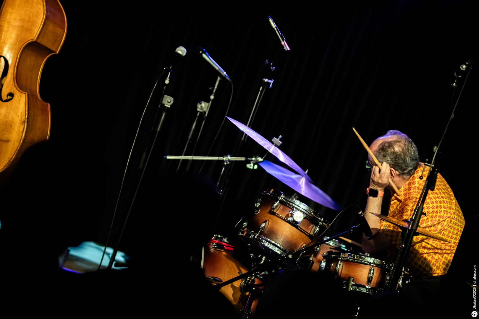 Musician playing drums on stage during performance