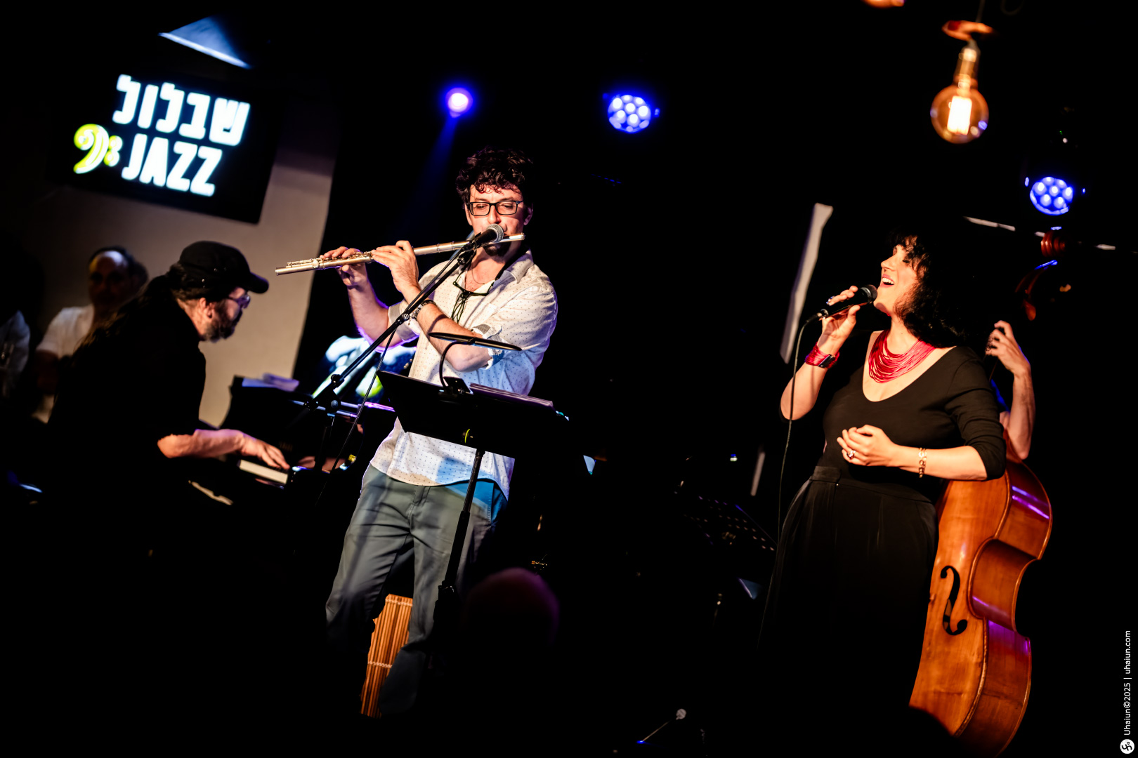 Live jazz band performing on stage with microphones