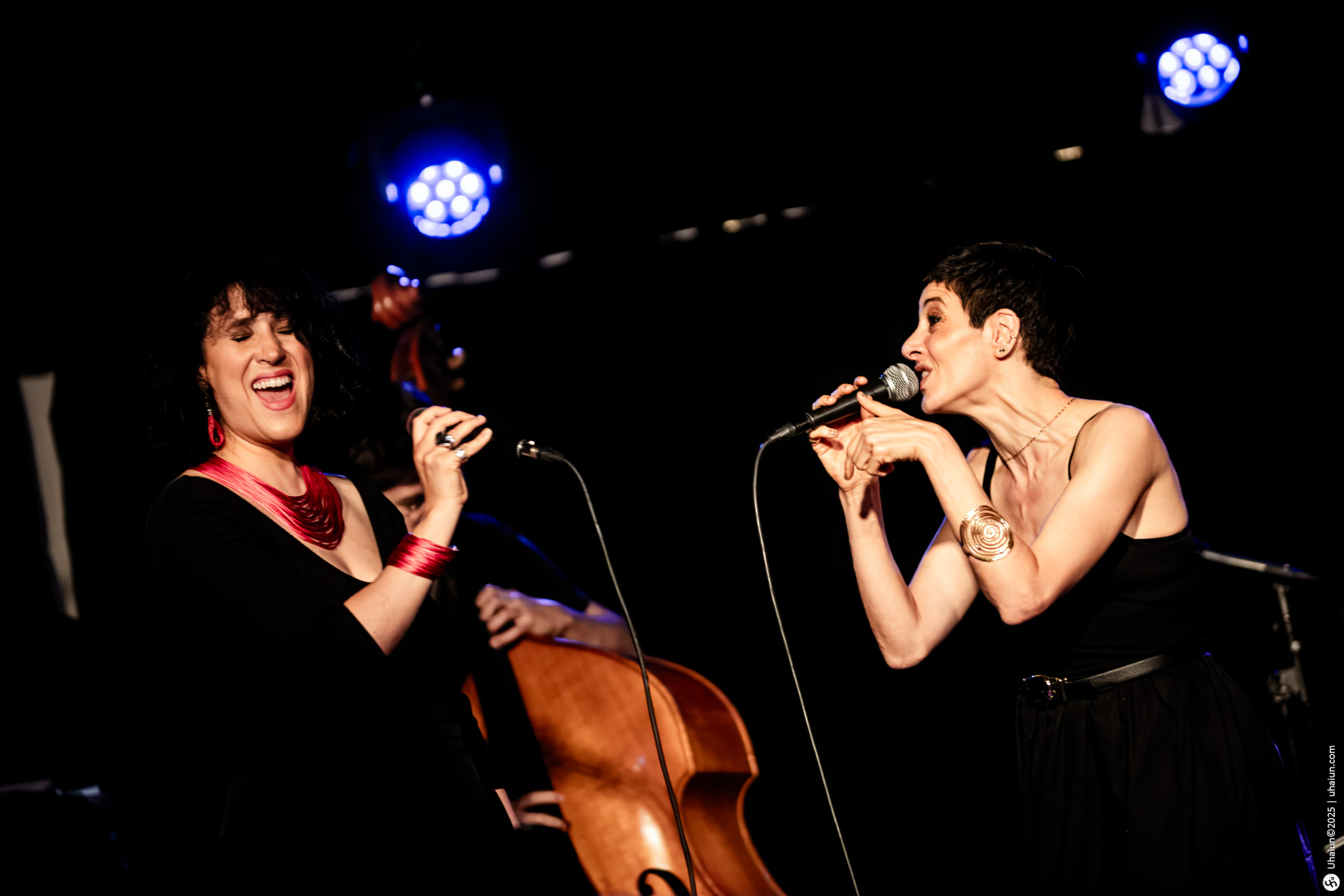 Two female musicians performing live on stage