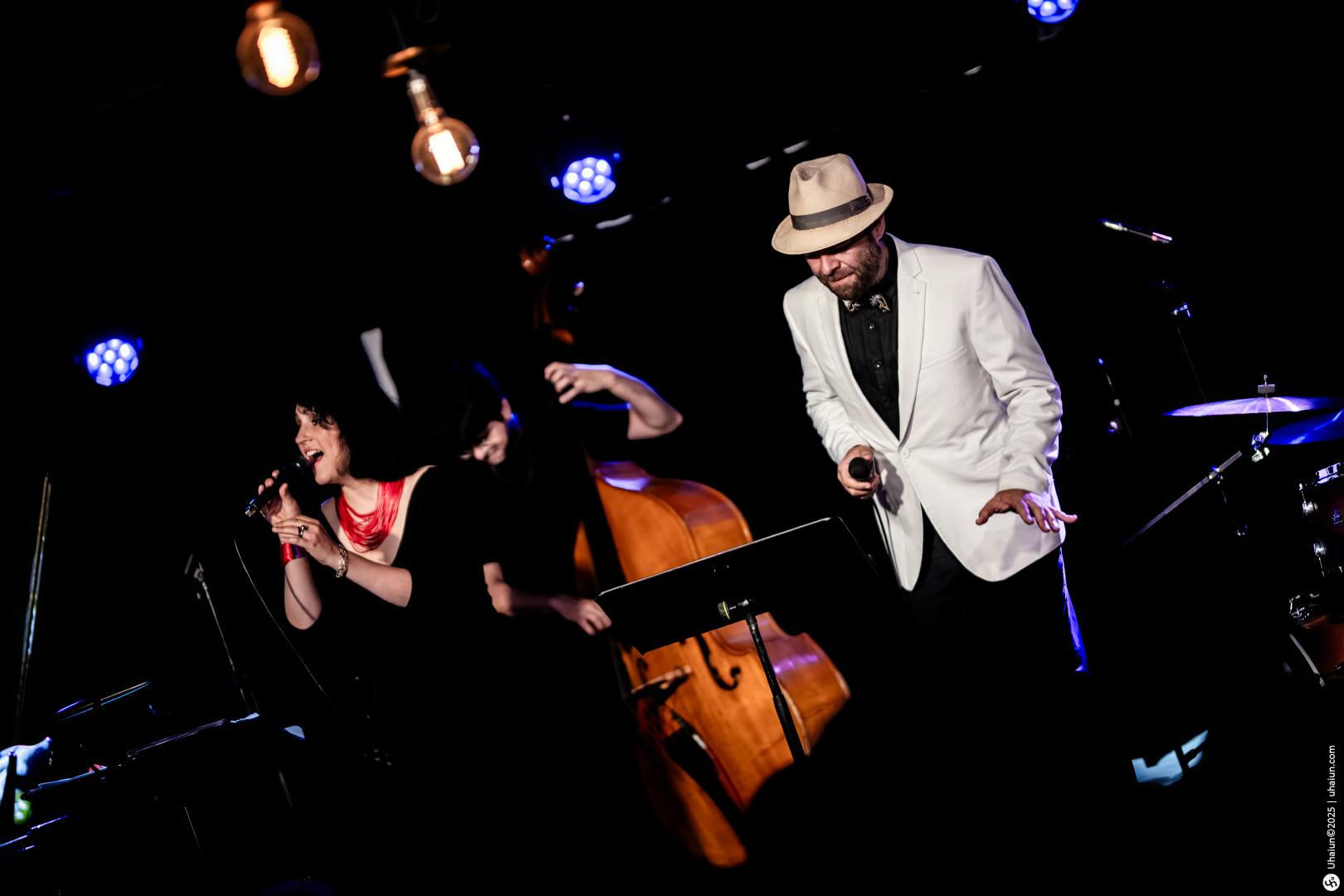 Musicians performing live jazz on stage enthusiastically