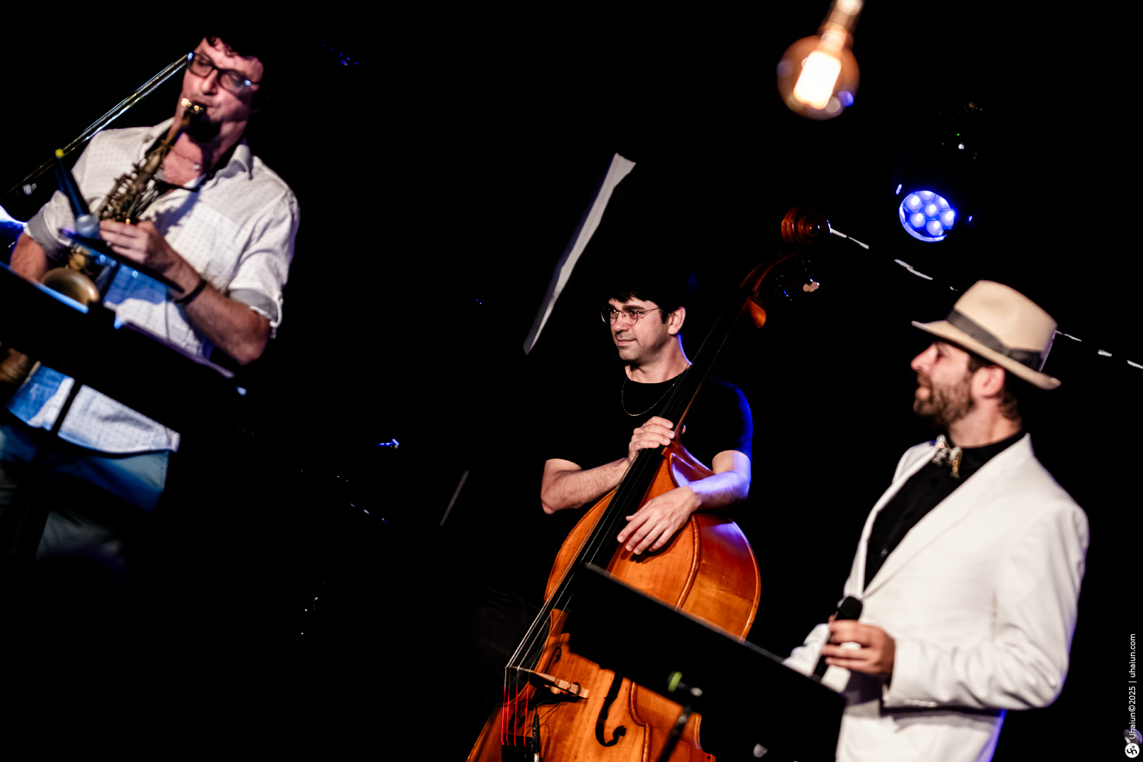 Jazz musicians performing live with instruments on stage
