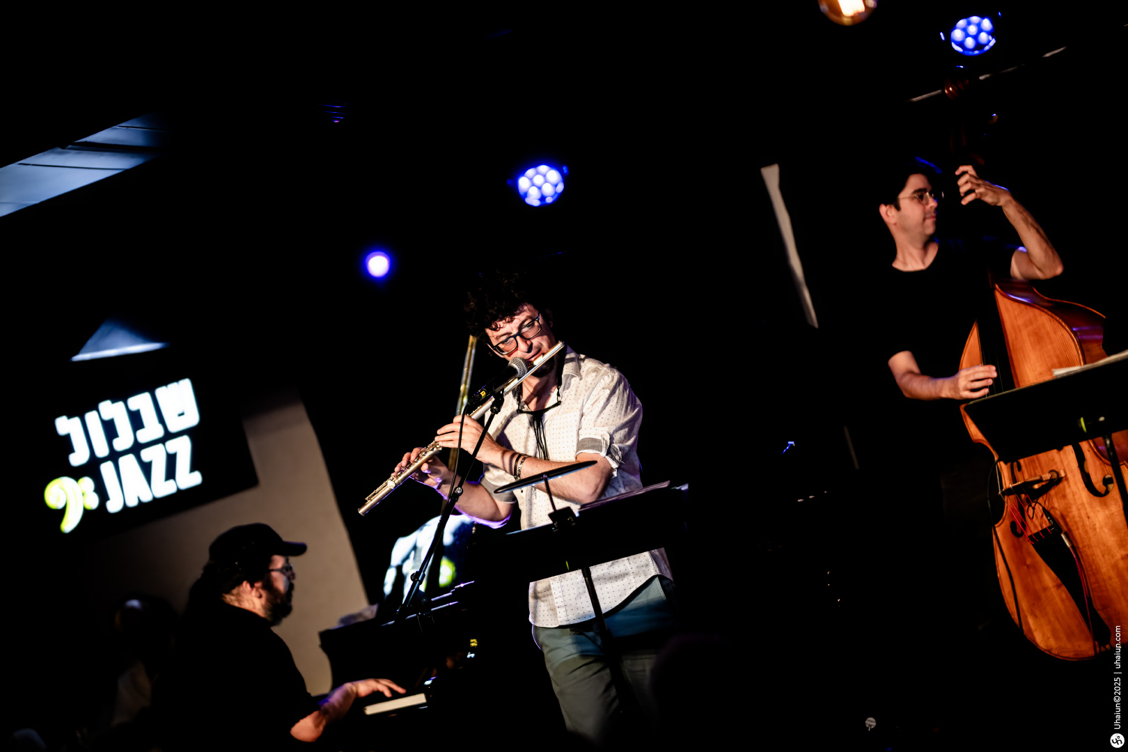 Musicians performing jazz music on stage live