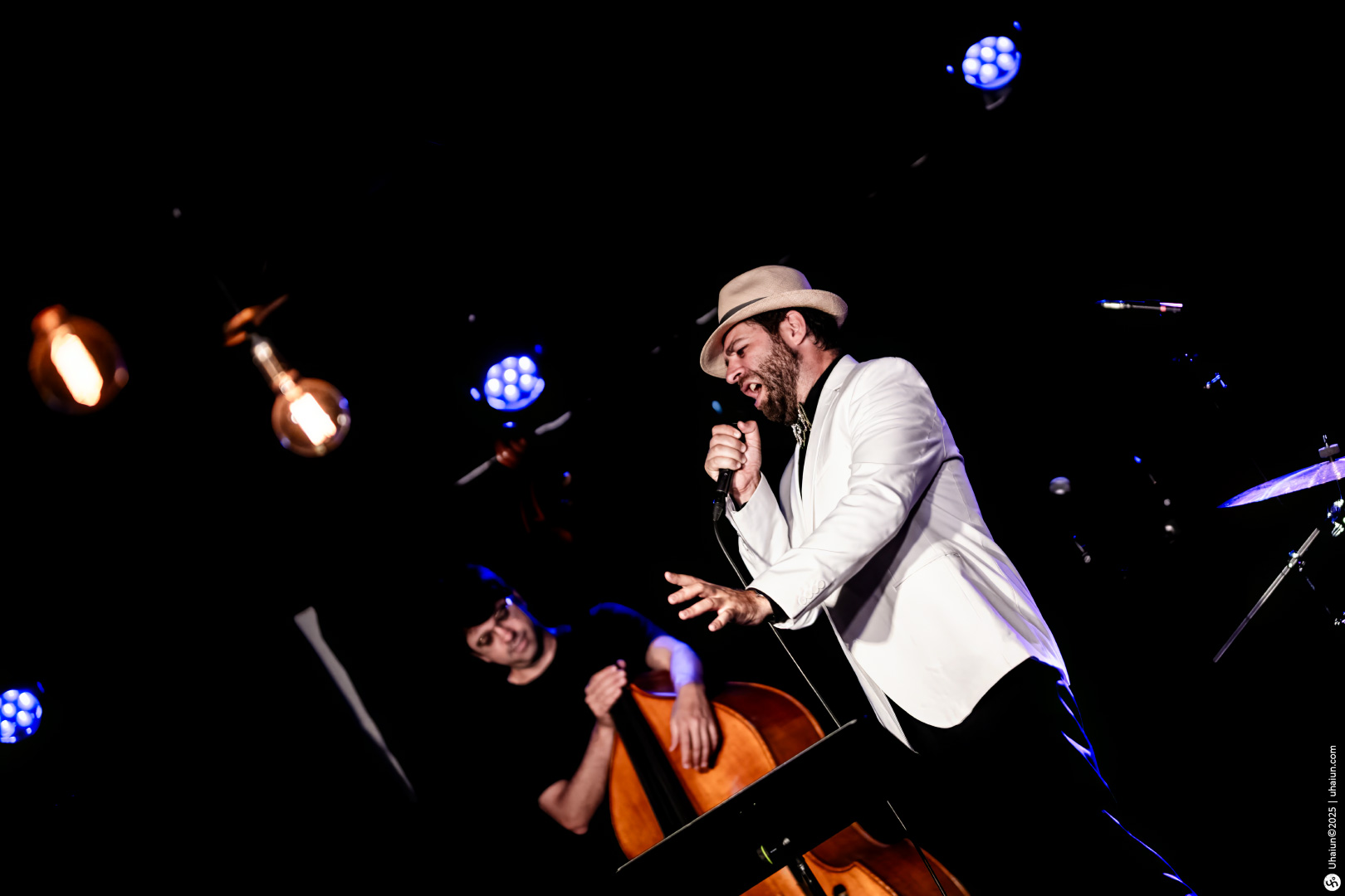 Musician performing passionately on stage with microphone