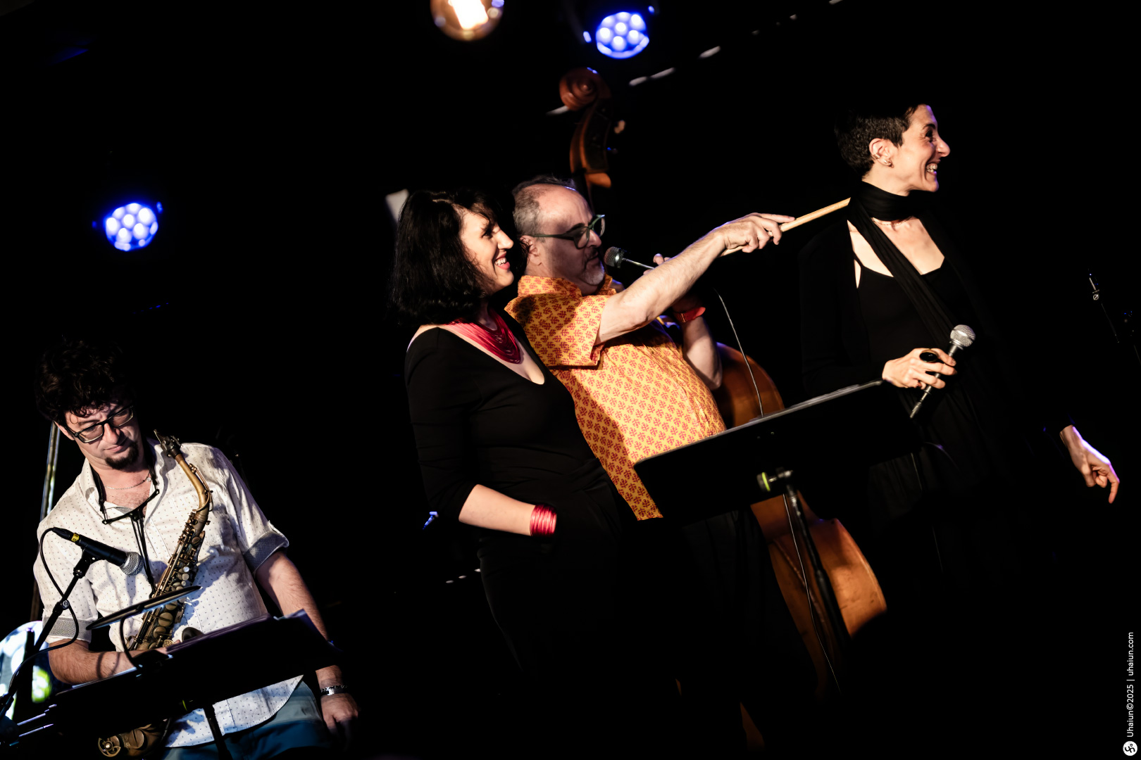 Musicians performing live on stage with instruments