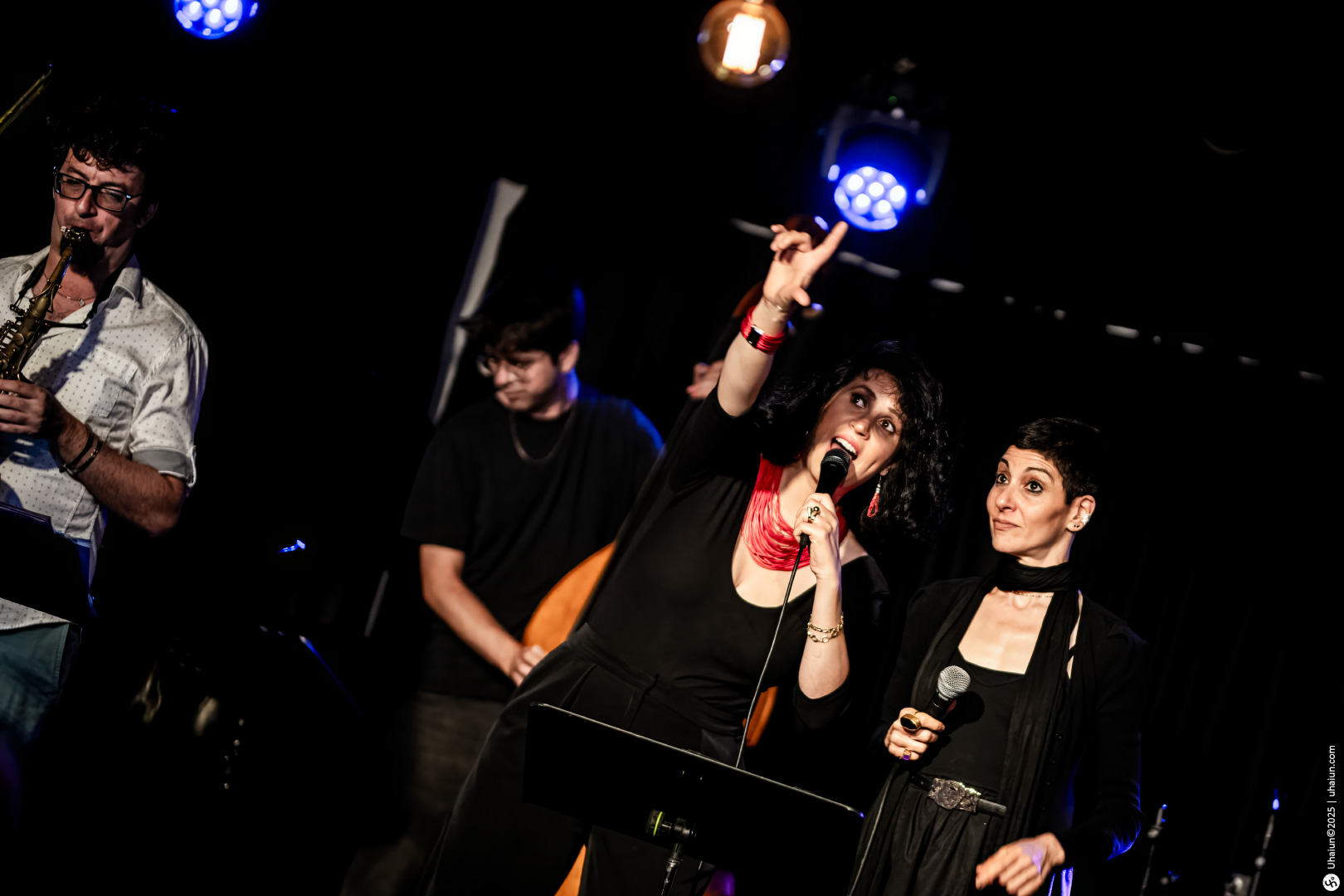 Musicians perform live on stage with enthusiasm