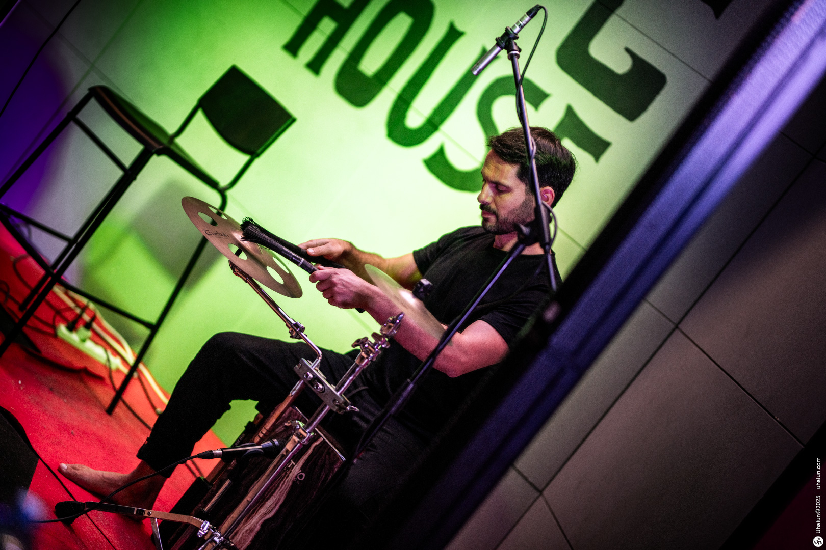 Drummer performing live at a music venue