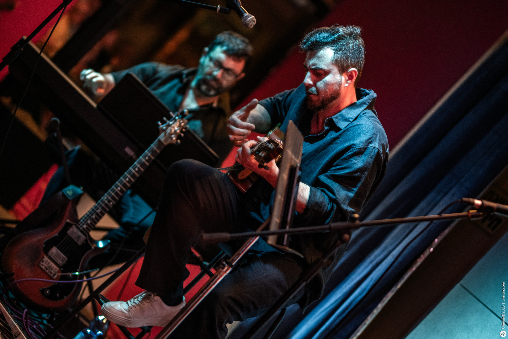 Musicians performing live with guitars on stage