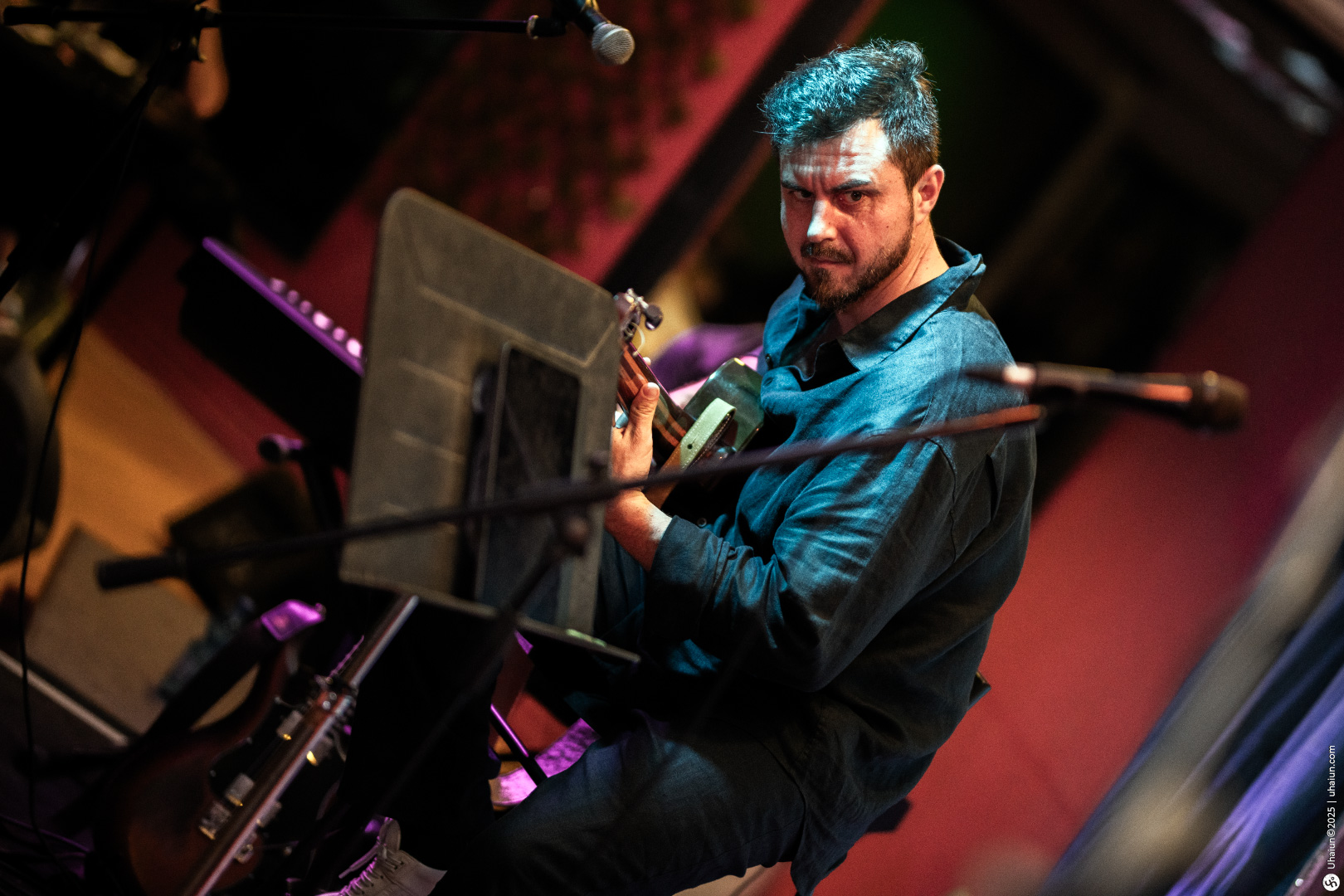 Musician playing guitar during live performance