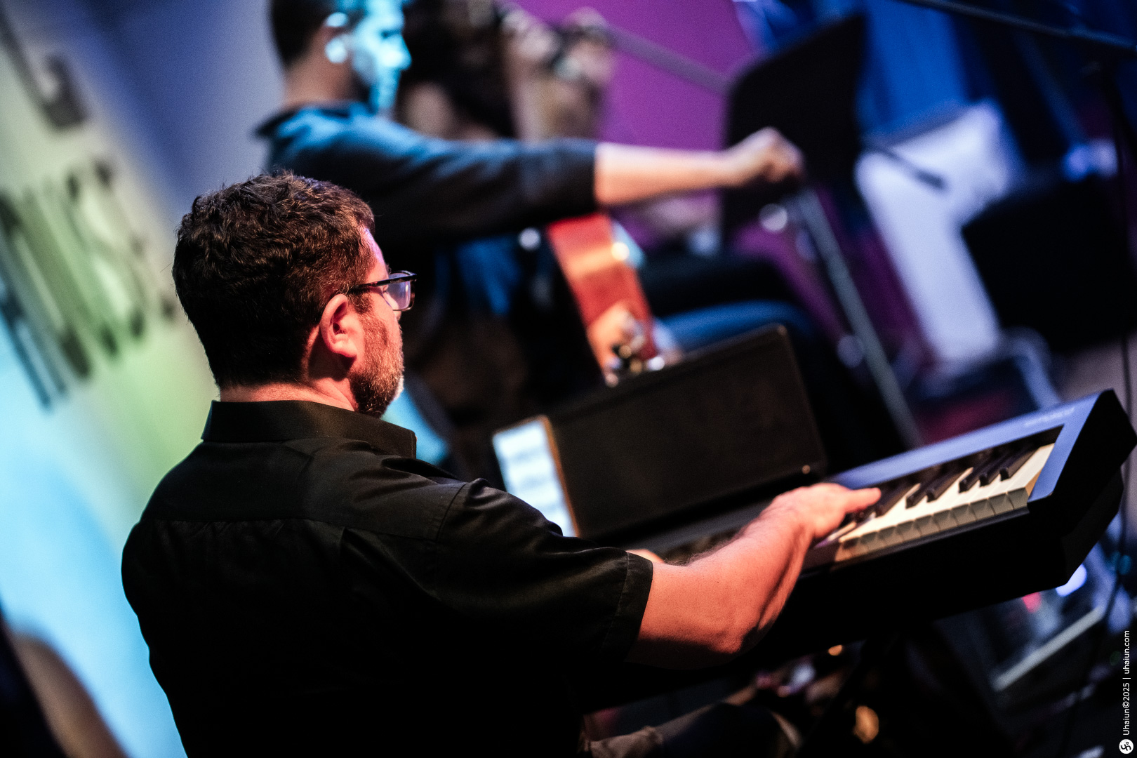 Musician playing keyboard at live music event