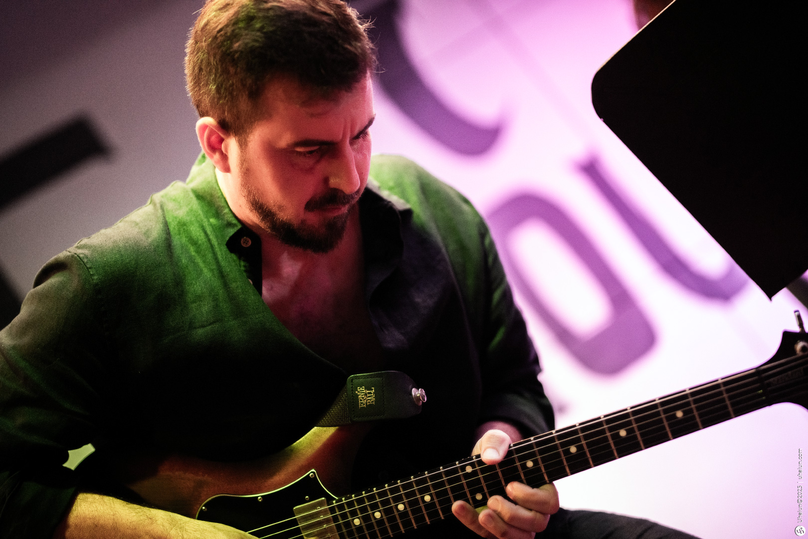 Musician playing electric guitar on stage performance