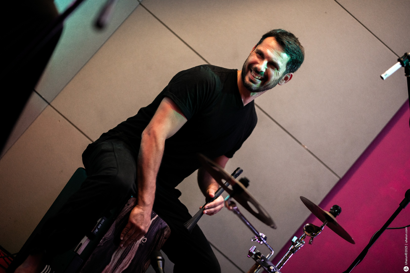 Musician playing drums with a joyful expression