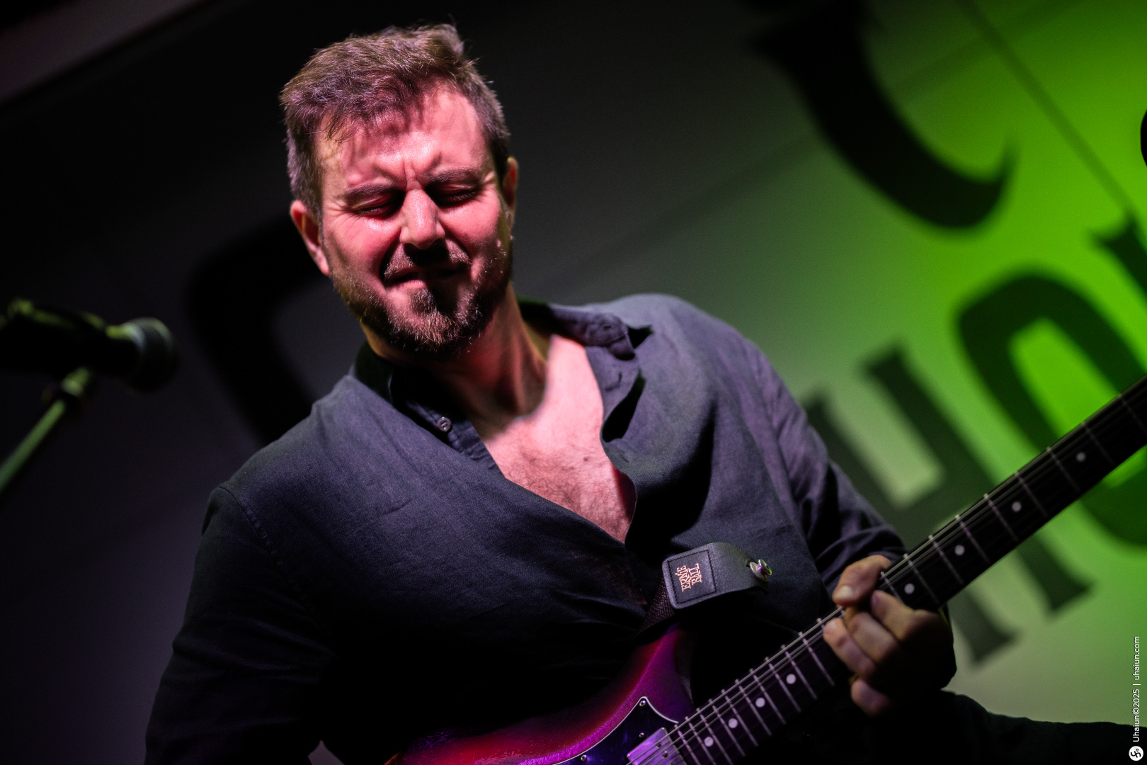 Guitarist passionately playing on stage performance