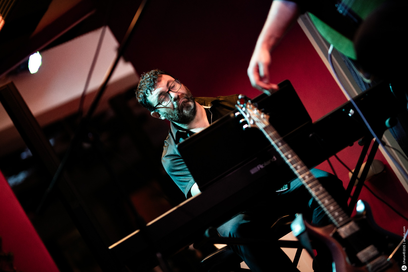 Musician playing keyboard at live music event