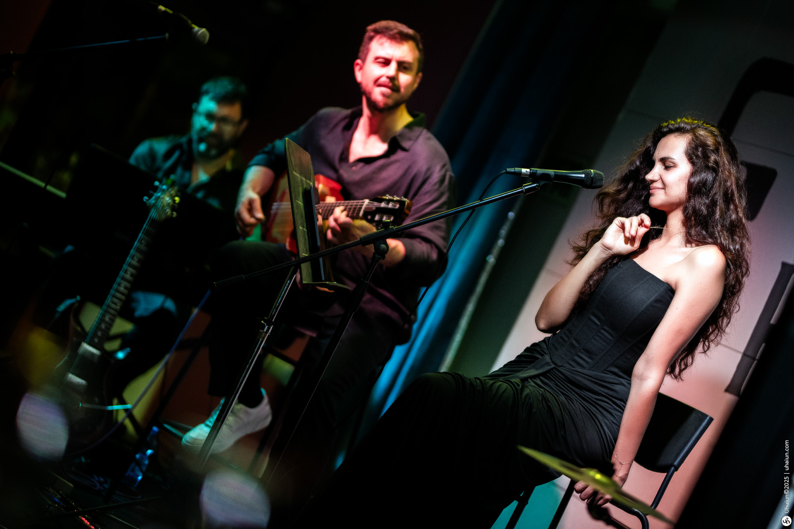 Musicians performing live on stage with instruments
