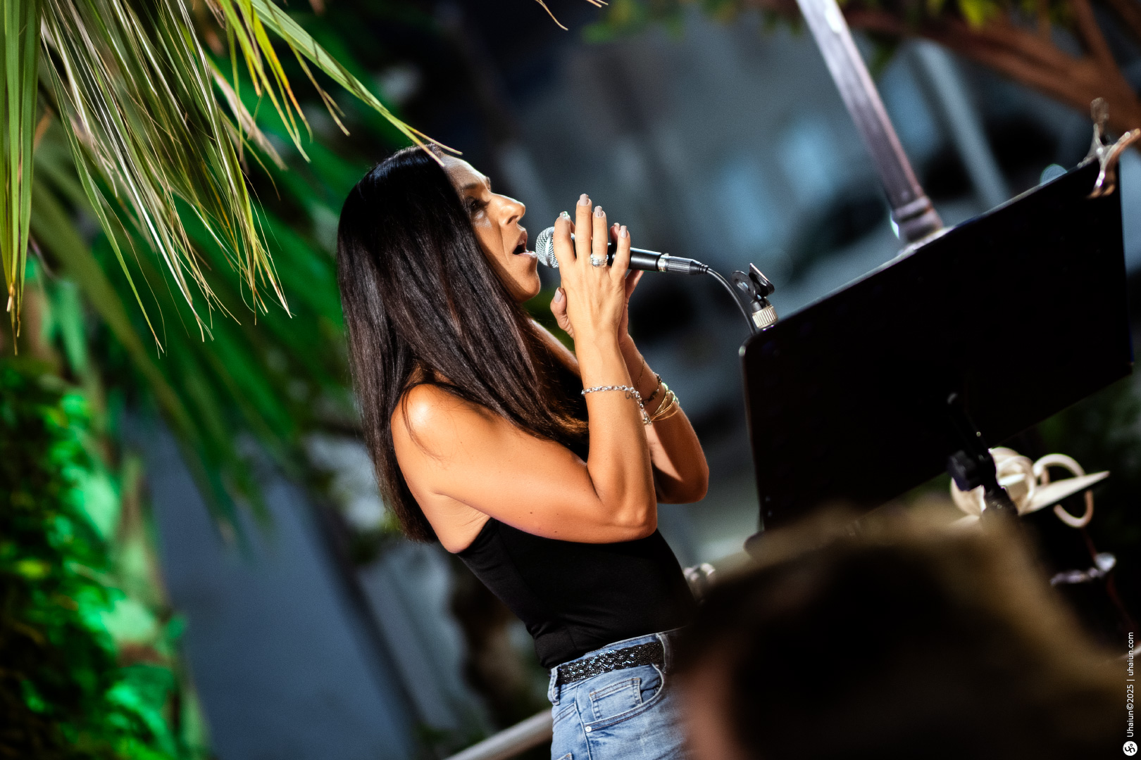 Woman singing at outdoor evening event microphone