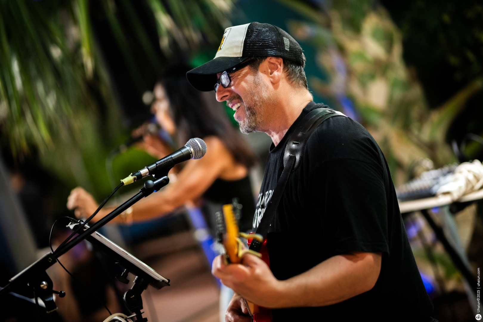 Musician performing live with guitar and microphone