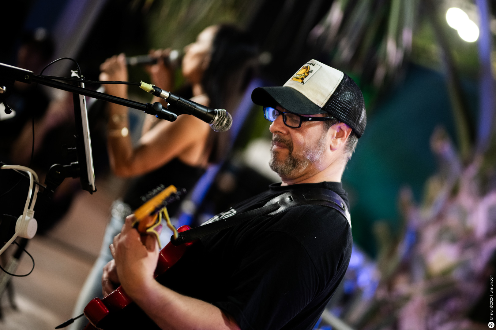 Man playing guitar during outdoor live performance