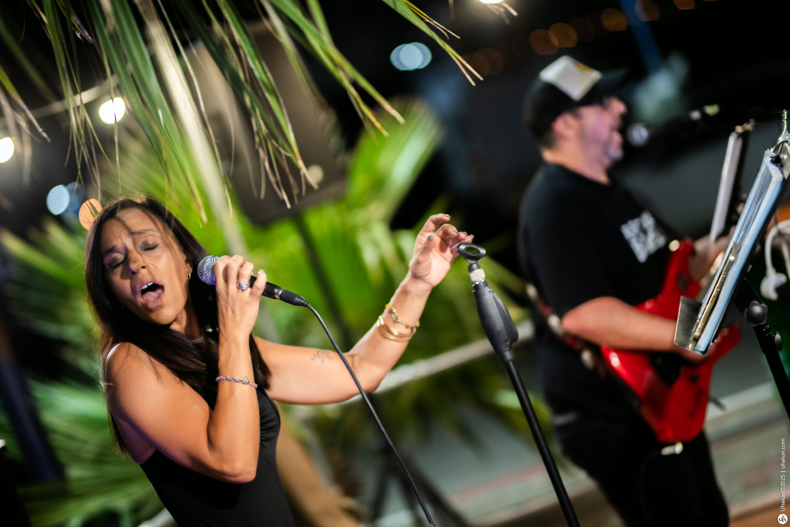 Singers performing live music on stage outdoors
