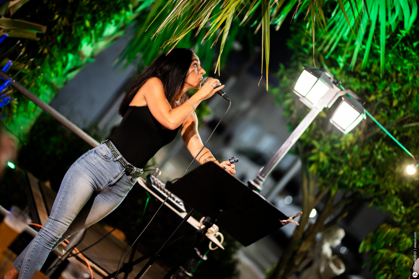 Woman singing outdoors at night event