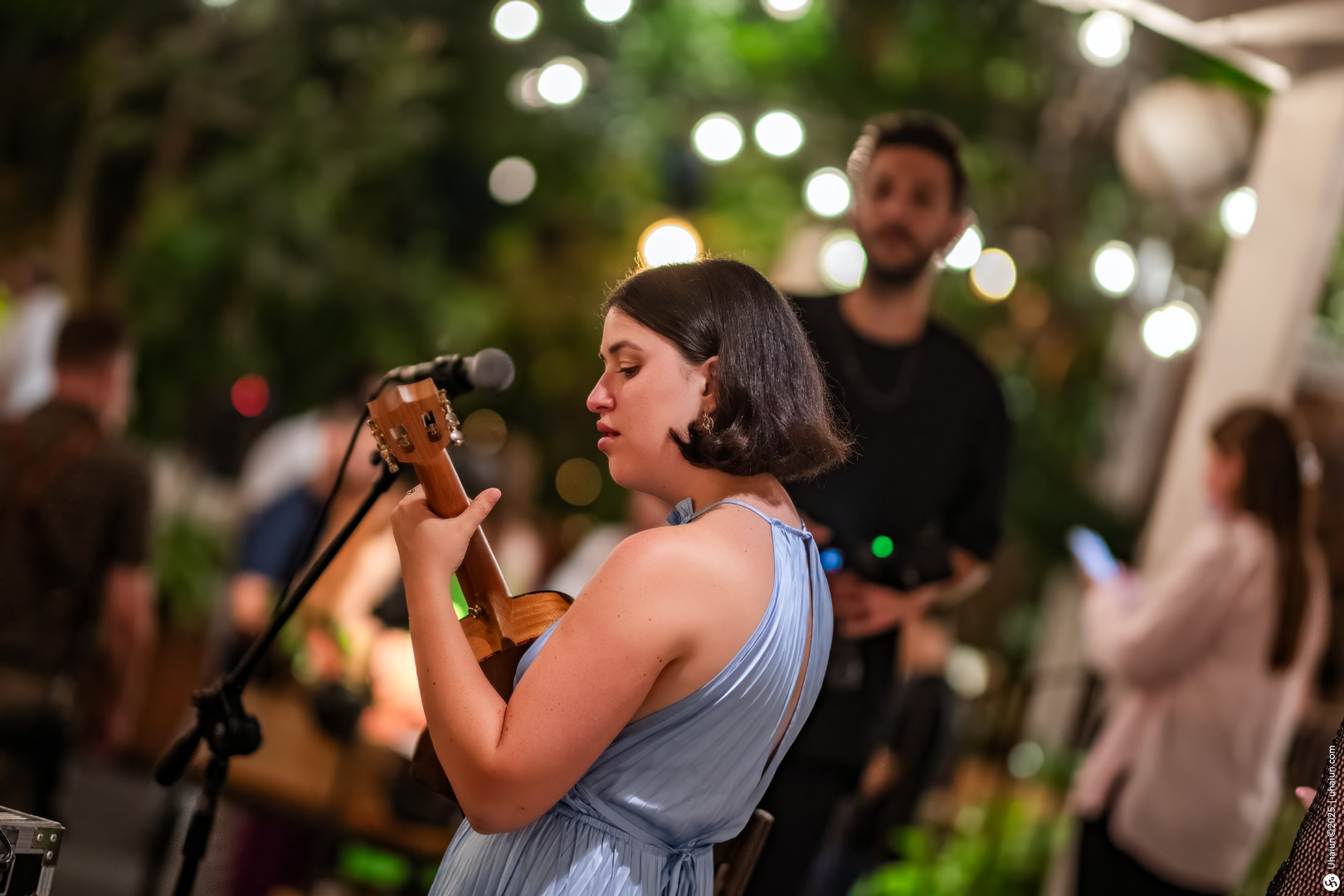 Musician playing guitar at outdoor wedding