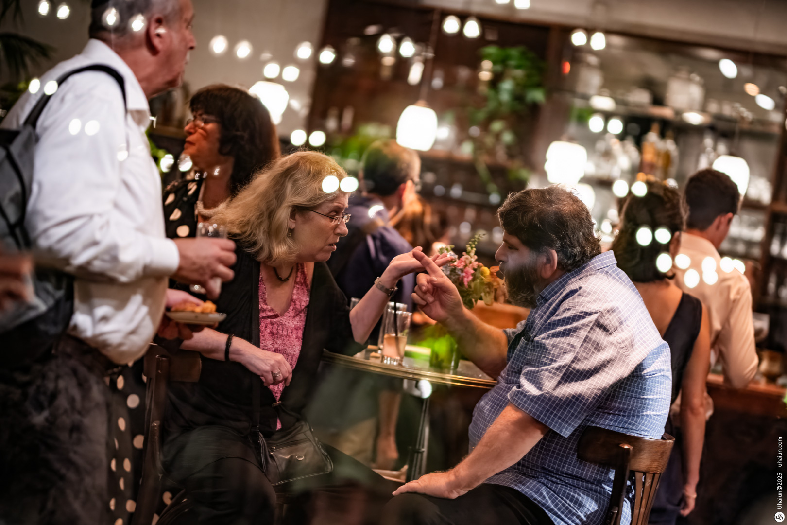 People enjoying conversation at a cozy restaurant