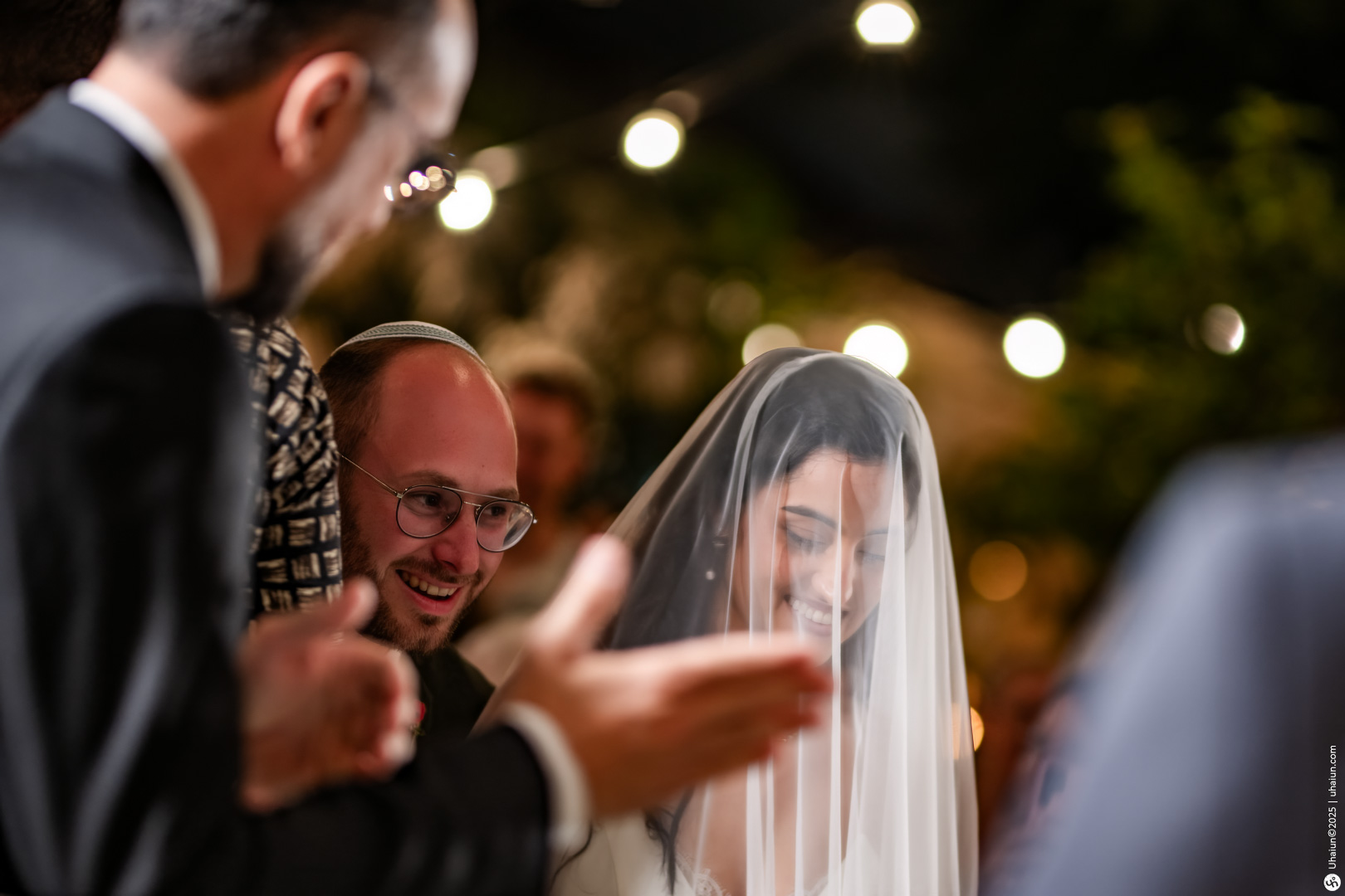 Bride and groom under wedding canopy smiling