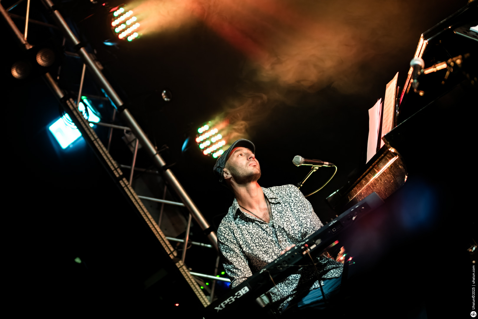 Musician performing live on stage with keyboard
