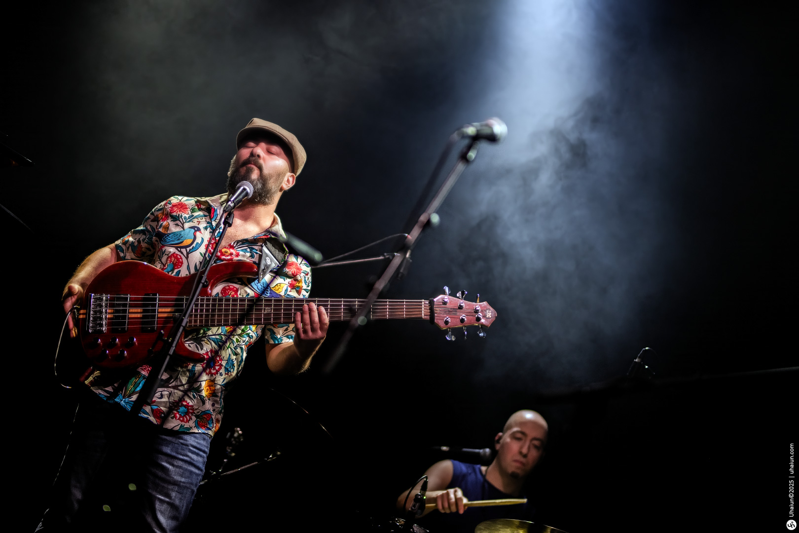 Musicians performing live on stage with instruments