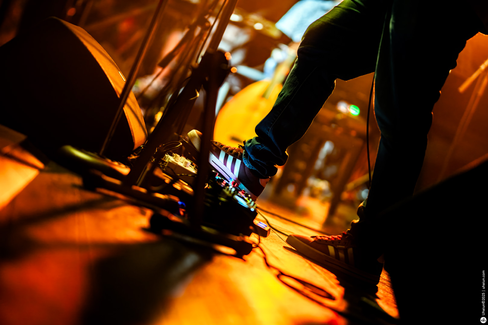 Musician using pedal board on stage performance