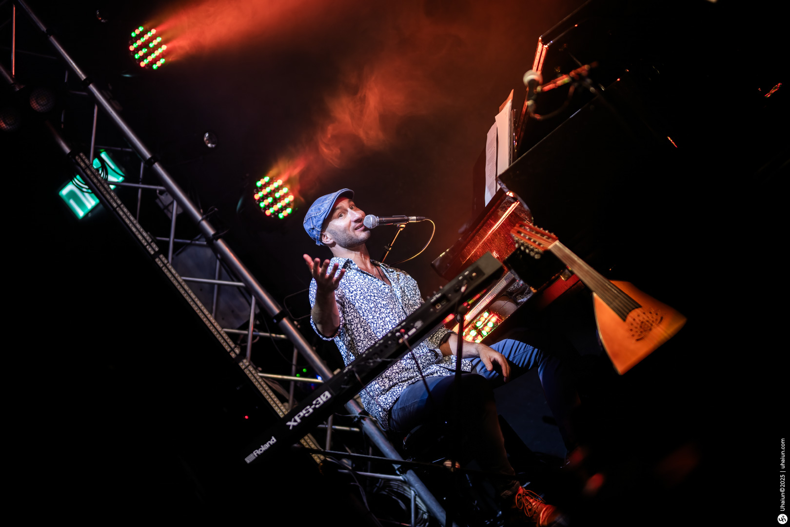 Musician performing on stage under vibrant lights