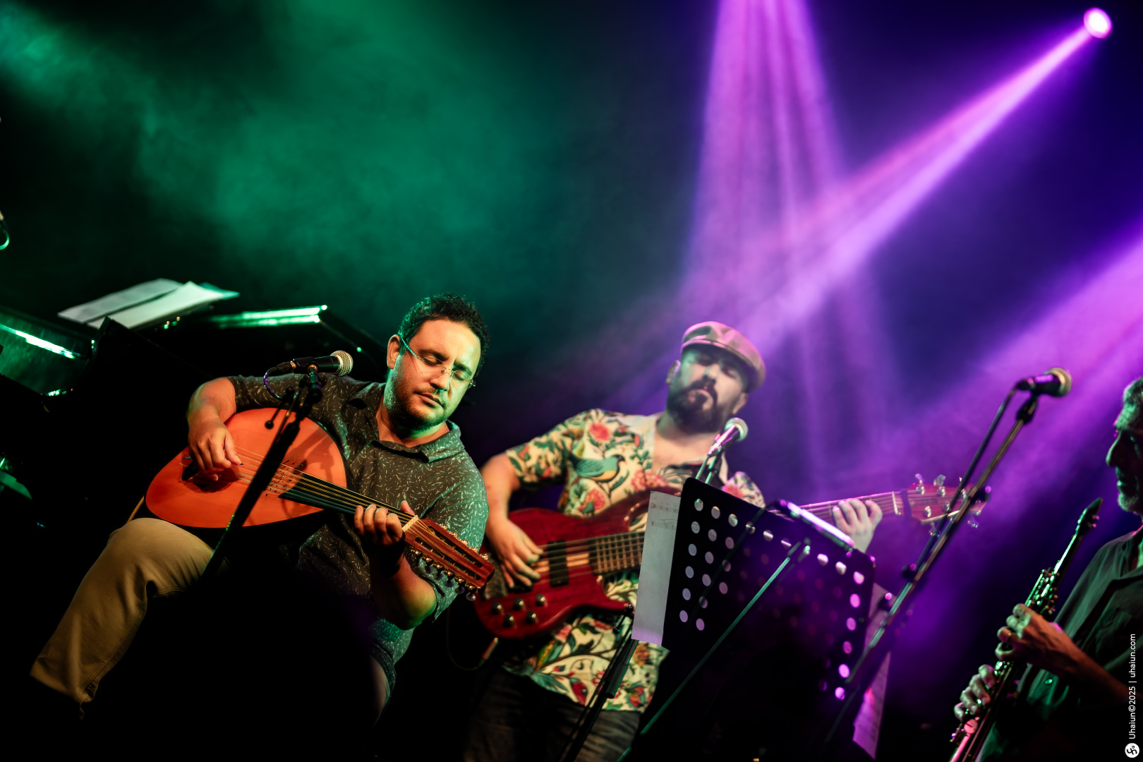 Musicians performing live on stage with instruments