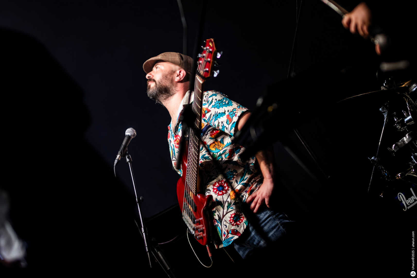 Musician performing live on stage with guitar
